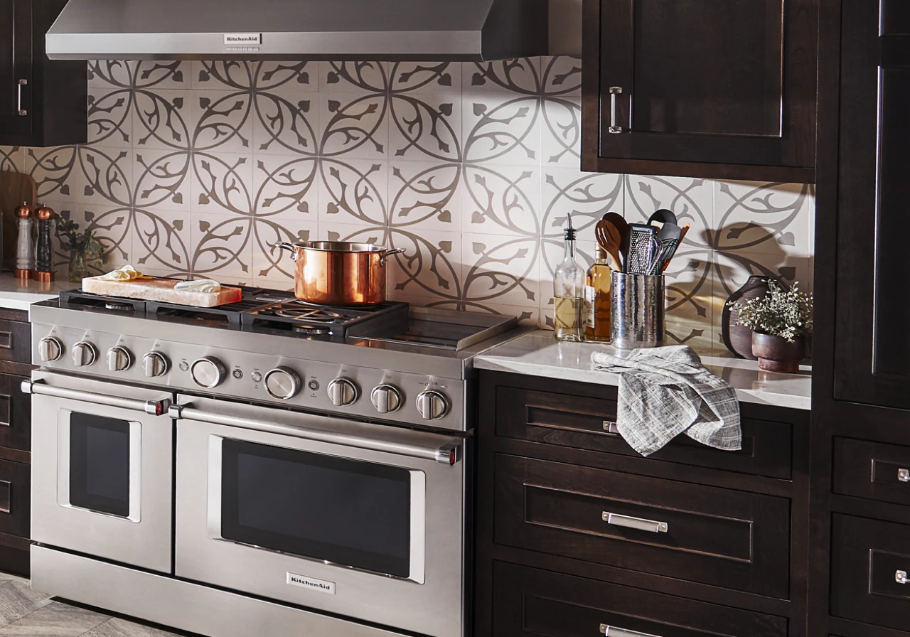 KitchenAid KFDC558JSS dual-fuel range in a dark wood kitchen