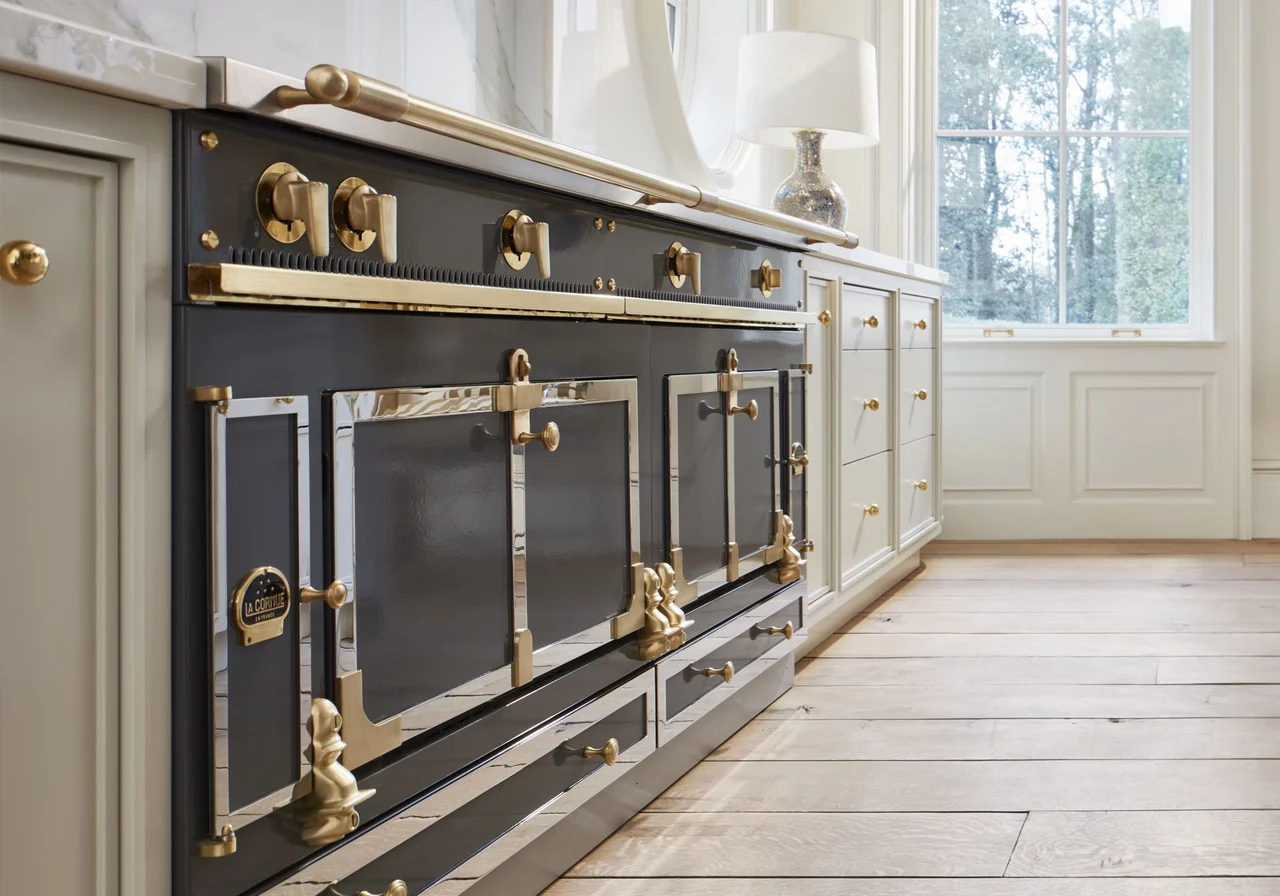 La Cornue Château range with brass trim in a bright French-inspired kitchen