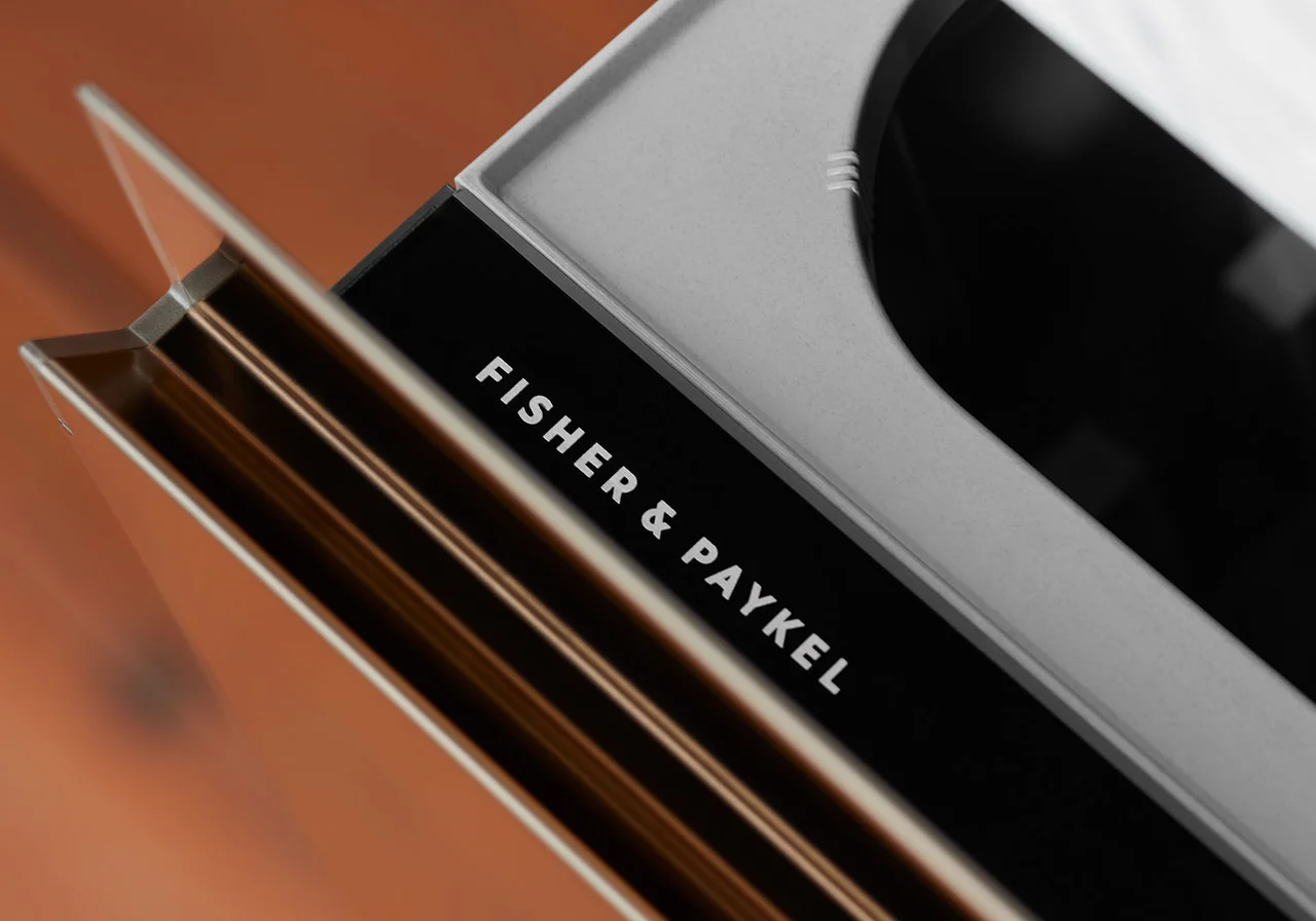 Close-up of an integrated Fisher & Paykel DishDrawer in bronze cabinetry