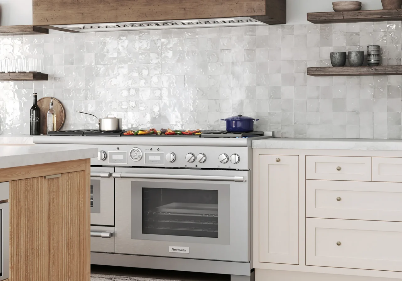 Thermador Pro Grand dual-fuel range installed in a light wood and white tile kitchen